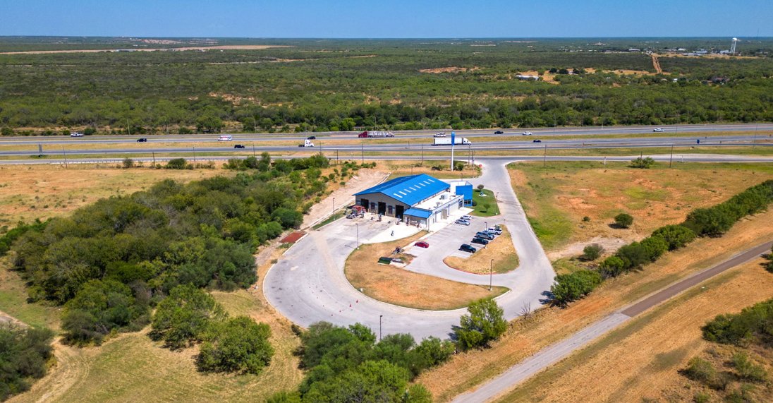 Aerial of Blue Steer next to I-35 highway